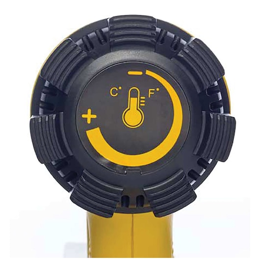 Close-up view of the DEWALT D26411 heat gun temperature control dial, featuring Celsius and Fahrenheit symbols, a thermometer icon, and a yellow adjustment marking on a black circular dial.