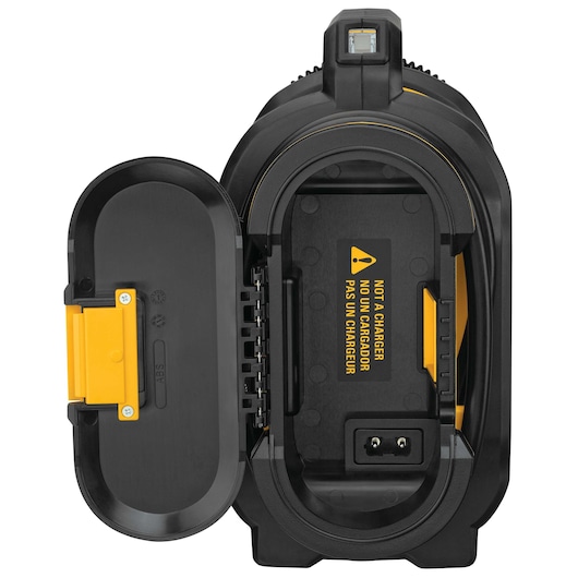 Close-up view of an opened DEWALT device, showing the battery compartment with a warning label that reads 'NOT A CHARGER' in yellow and black.