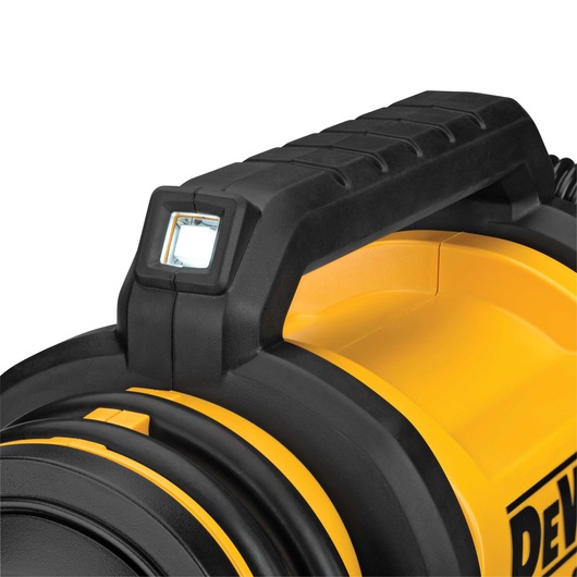 Close-up view of the handle and LED light on a yellow and black DEWALT photography equipment case.