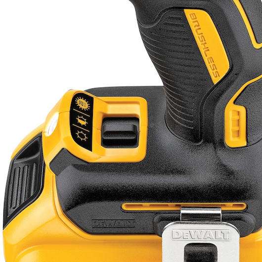 Close-up of a DEWALT cordless drill handle with brushless motor and a three-setting light control switch.