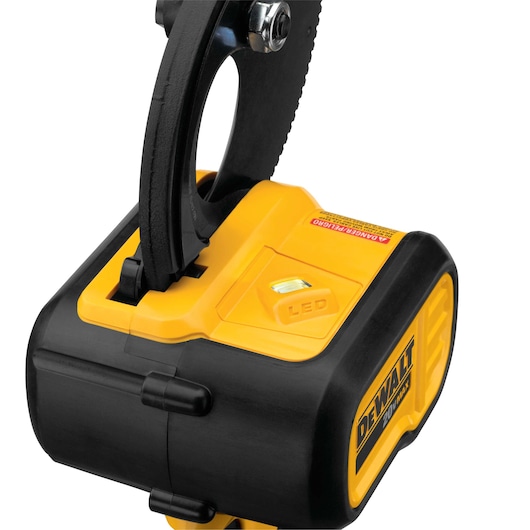 Close-up view of a DEWALT 20V MAX cordless cable cutting tool, showing part of the blade mechanism and the yellow and black body with an LED indicator and warning label.