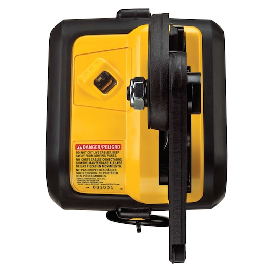 Close-up view of a DEWALT power tool with a yellow and black body, featuring a safety warning label in multiple languages and visible mechanical components.