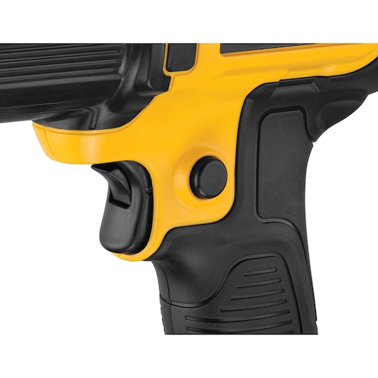 Close-up view of the handle and trigger area of a DEWALT power tool, showing a yellow and black ergonomic grip with a trigger and button.