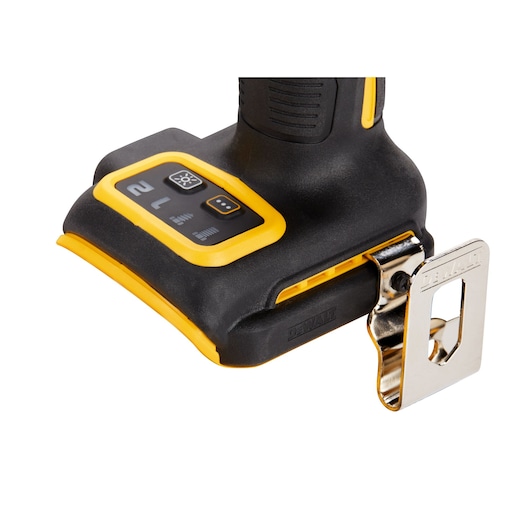 Close-up image of the base of a DEWALT power tool, showing control buttons with yellow accents and a metal belt clip attached.