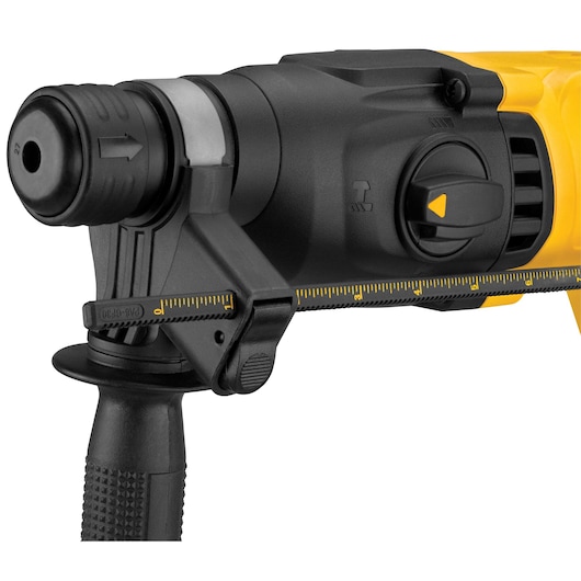Close-up view of the front part of a DEWALT rotary hammer drill, showing the handle, depth gauge, and control switch in detail. The tool is primarily black and yellow.