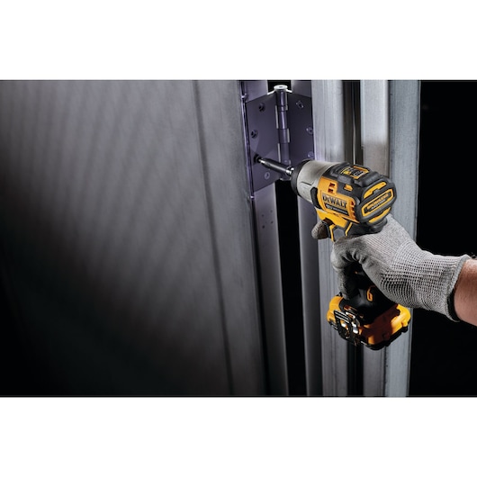 XTREME Brushless cordless impact driver fastening screw in hinge.