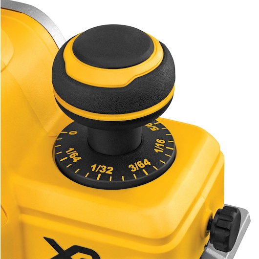 Close-up view of a yellow and black DEWALT tool adjustment knob featuring measurement markings in fractions of an inch.