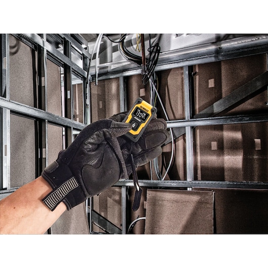 Atomic compact series pocket laser distance measurer being used to measure a distance.