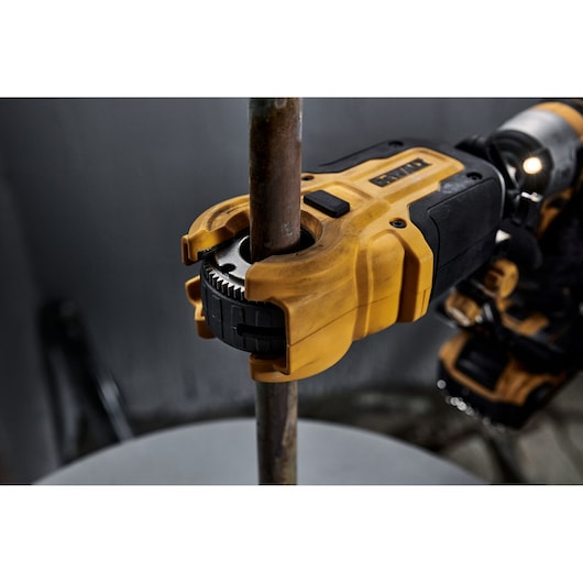 Close up of DEWALT IMPACT CONNECT Copper Cutter attachment on Impact Driver to cut copper pipe.