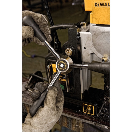Close-up view of a DEWALT control panel featuring buttons, including a power button, overload indicator, and red and green start/stop switches.