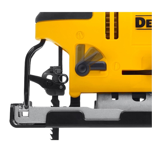 Close-up view of a DEWALT jigsaw, showing the yellow body, adjustment lever, and exposed metal saw blade at the bottom.