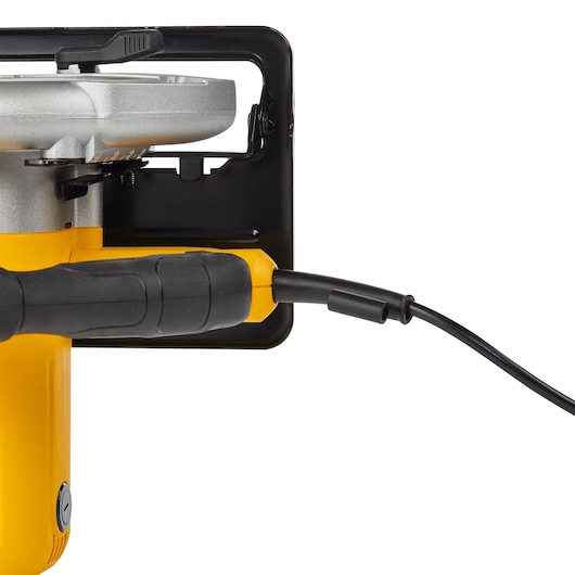 Close-up of a DEWALT DWE5615 electric power tool showing the yellow handle, power cord, and part of the metal base.