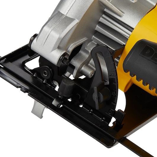 Close-up image of a DEWALT DWE5615 circular saw, showing the adjustment mechanism and part of the handle in yellow and black.