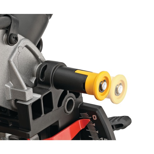 Close-up view of a DEWALT DWS713 miter saw component, showing the yellow and black detent stop and indicator near the angle scale.